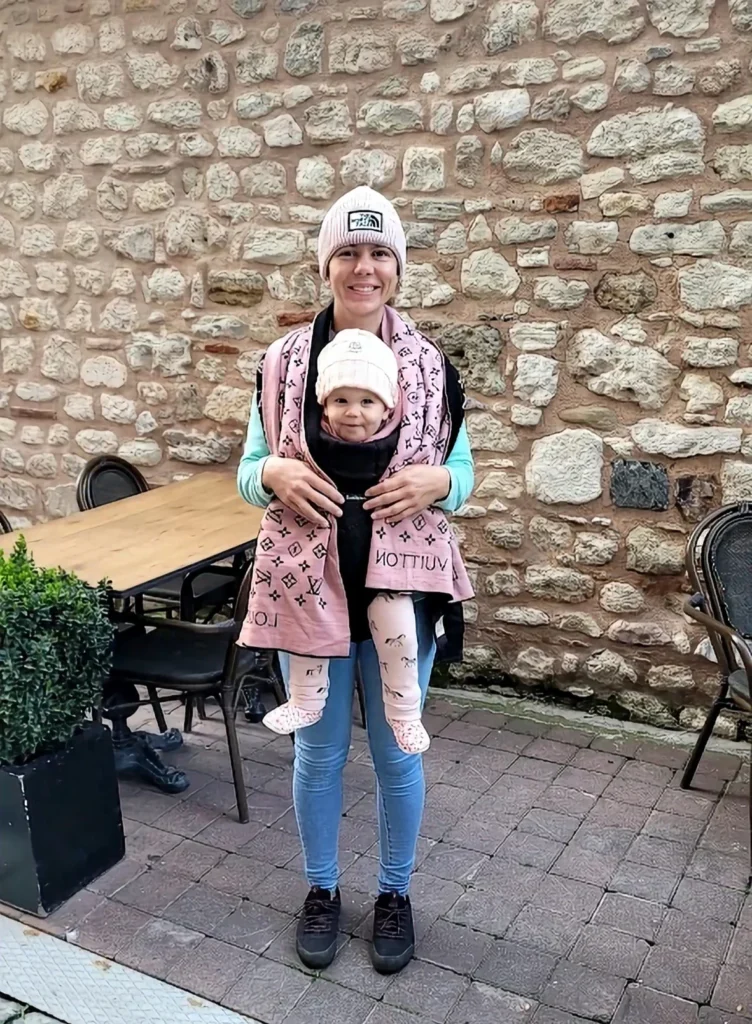 mum holding her baby in a carrier in istanbul