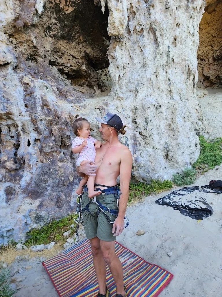 dad holding his baby rock climbing in south west WA