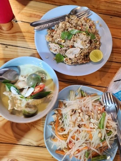a delicious lunch in thailand thai green curry, papaya salad and chicken fried rice