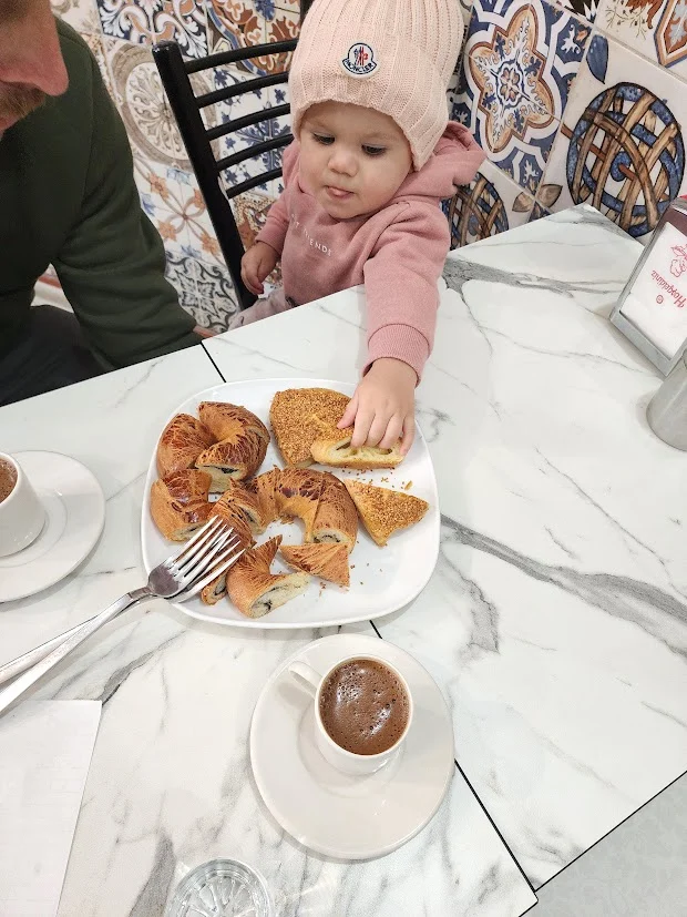baby girl reaching for turkish sweets in istanbul