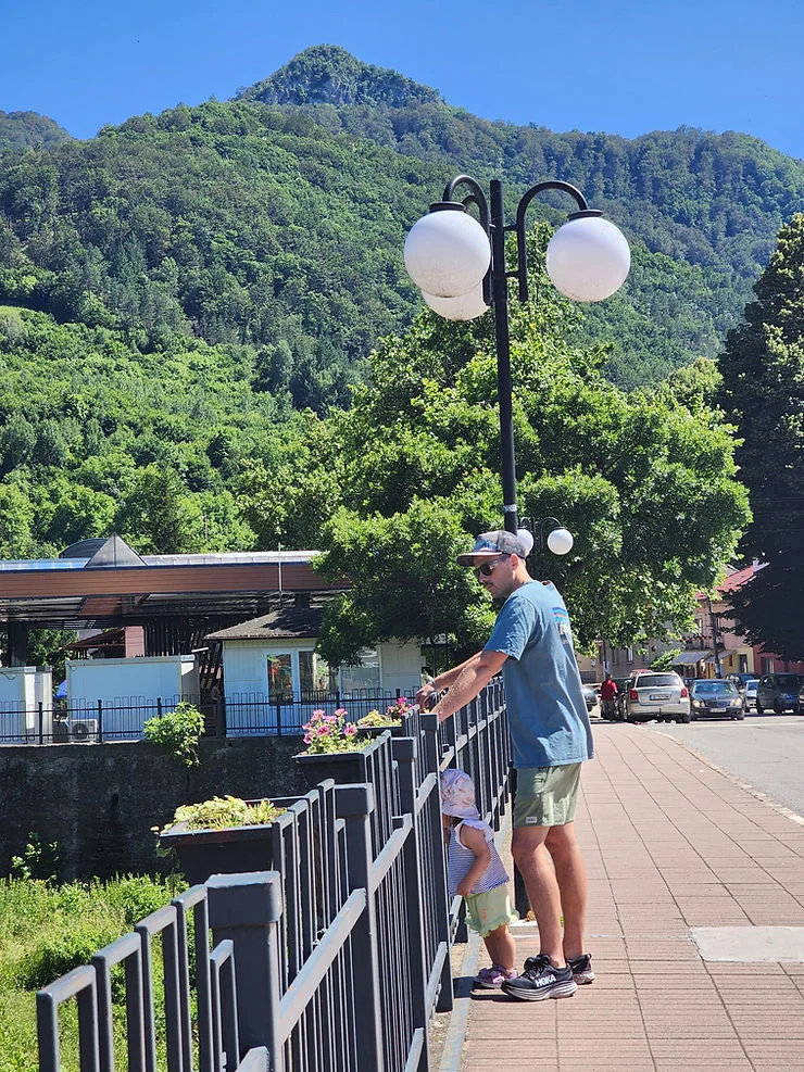 dad and daughter looking over the bridge in mountain town teteven bulgaria