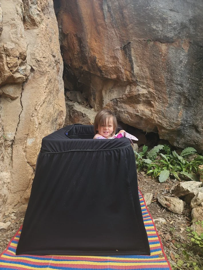 baby sleeping in the jungle in thailand while mum and dad go rock climbing