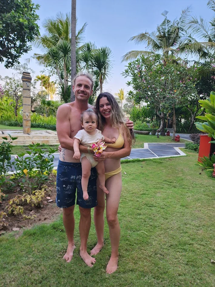 mum and dad holding their baby smiling in bali