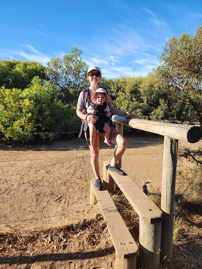 mum overwhelmed holding her baby going for a hike