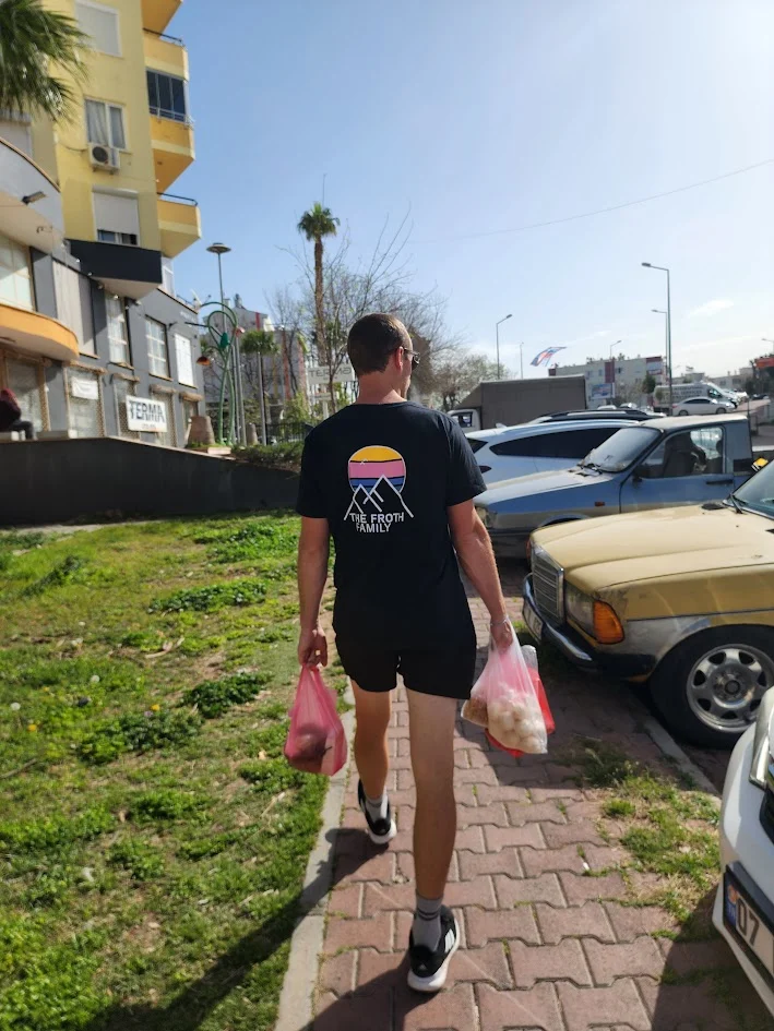 dad walking back to the car in turkey carrying the groceries from the market