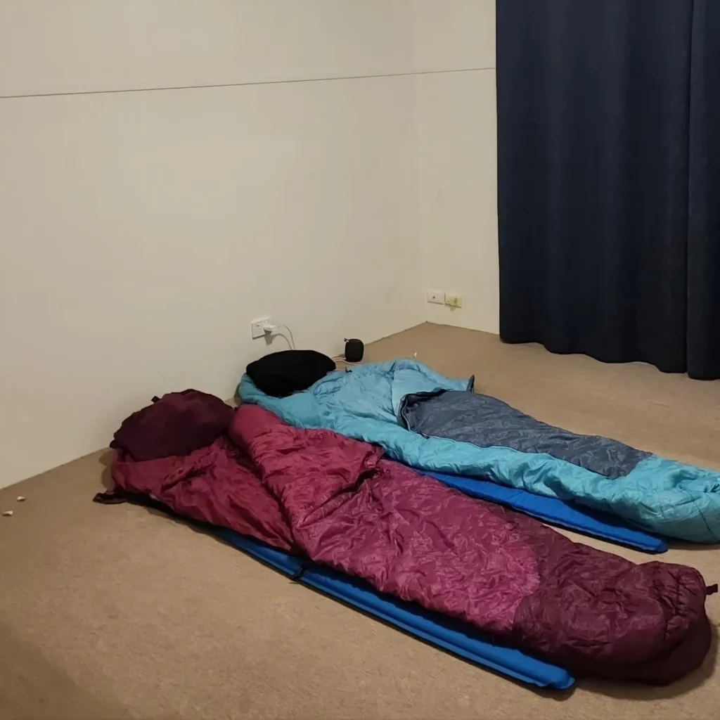 Two sleeping bags on the floor of an empty house—symbolizing the final nights before moving out.