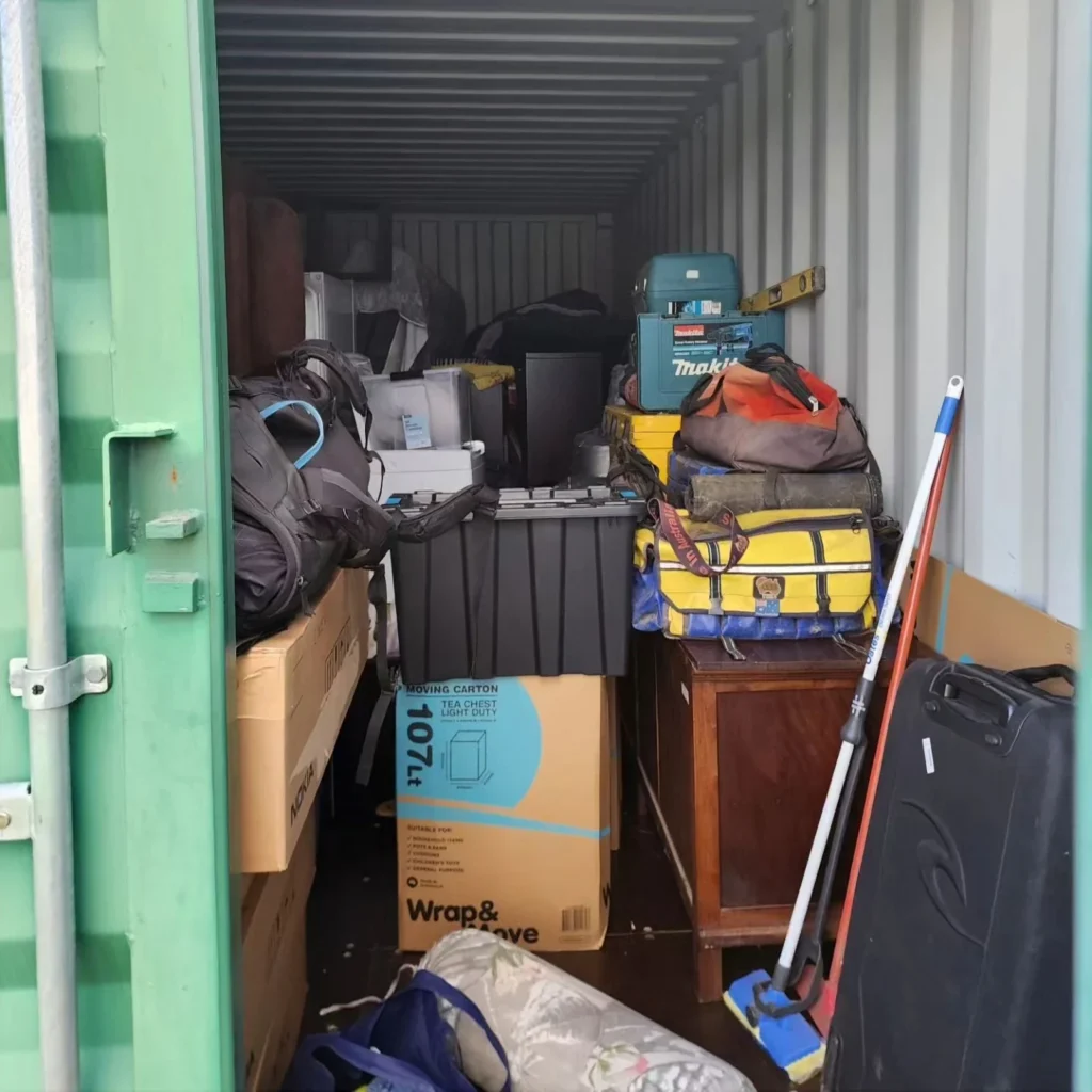 Some of the family’s belongings stacked in a storage container—fridge, drawers, etc., ready to store long-term.