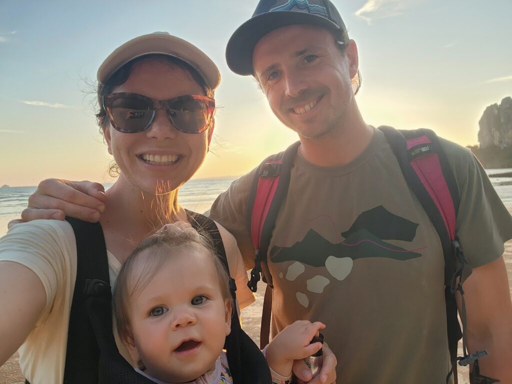 mum dad and baby on a beach in thailand for sunset